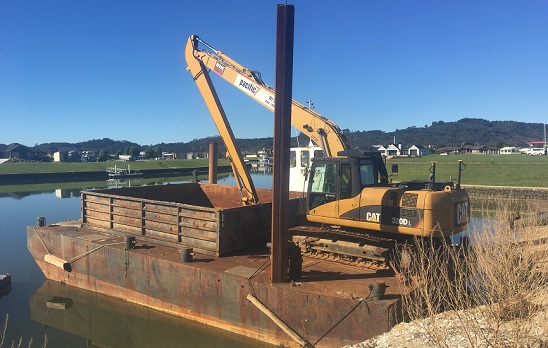Topcon machine control technology on its barge-mounted Cat 320D long-reach excavator